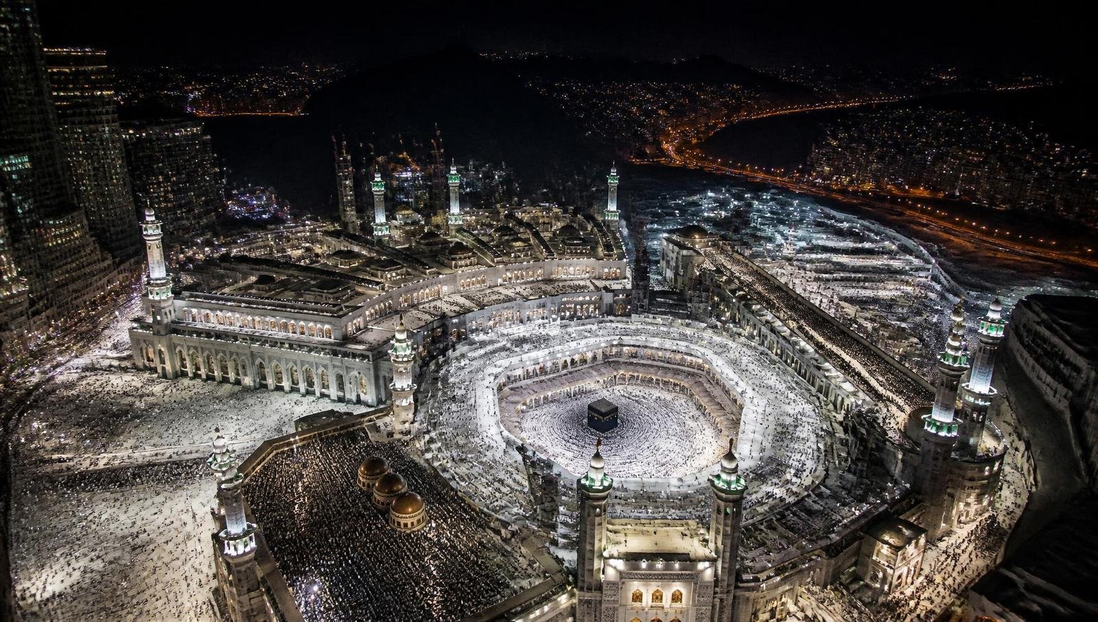Masjid al-Haram illuminated at night, seen from above